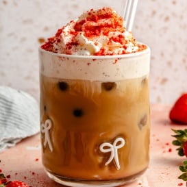 berry chantilly latte topped with whipped cream in a glass