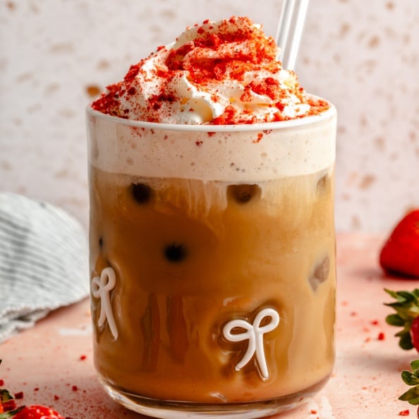 berry chantilly latte topped with whipped cream in a glass