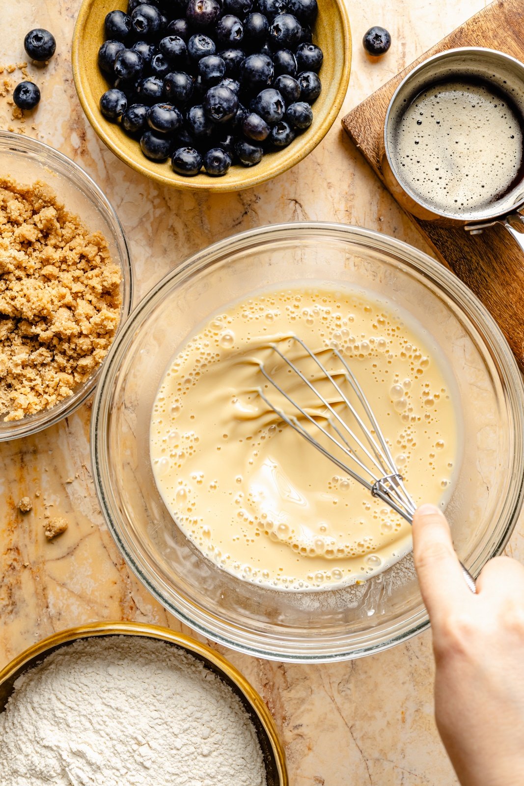 mixing batter for blueberry coffee cake
