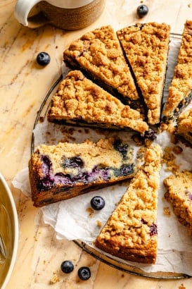 blueberry coffee cake cut into slices on parchment paper