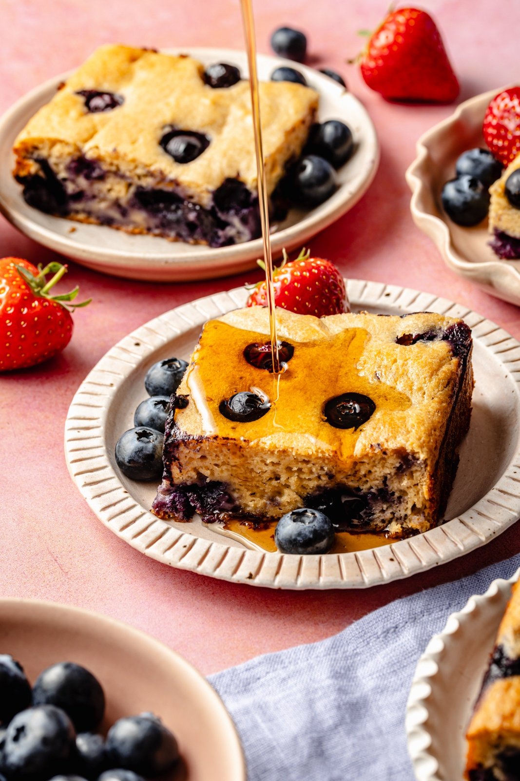 pouring syrup onto a slice of protein breakfast cake