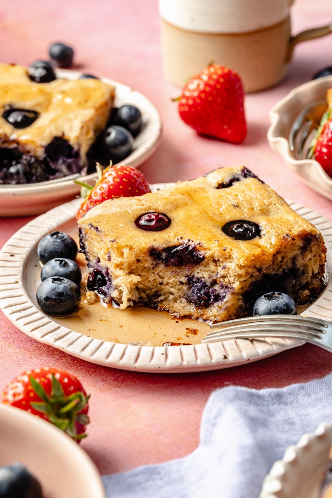 slice of protein breakfast cake with blueberries on a plate