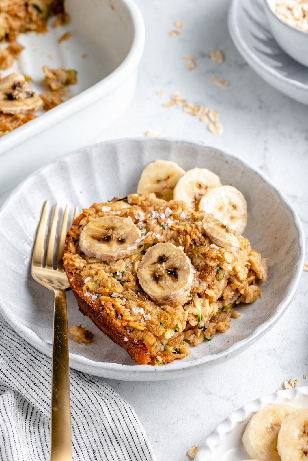 slice of banana zucchini oatmeal bake in a bowl