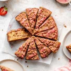 strawberry coffee cake sliced on parchment paper