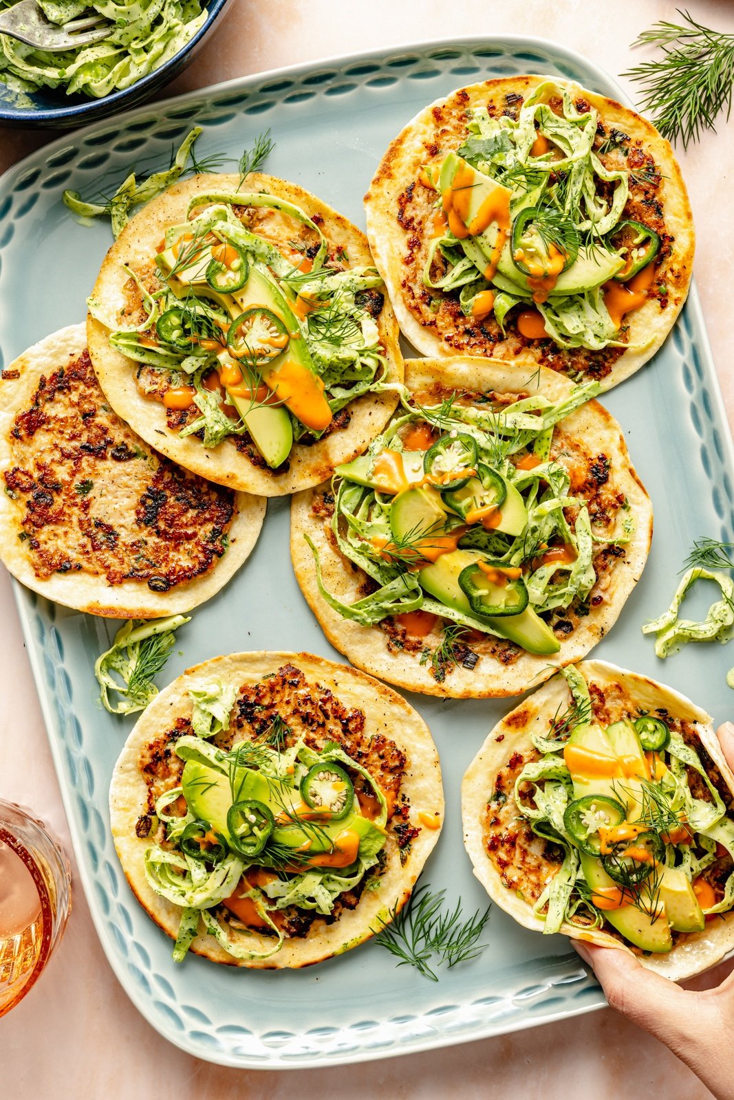 platter of smashed buffalo chicken tacos with slaw