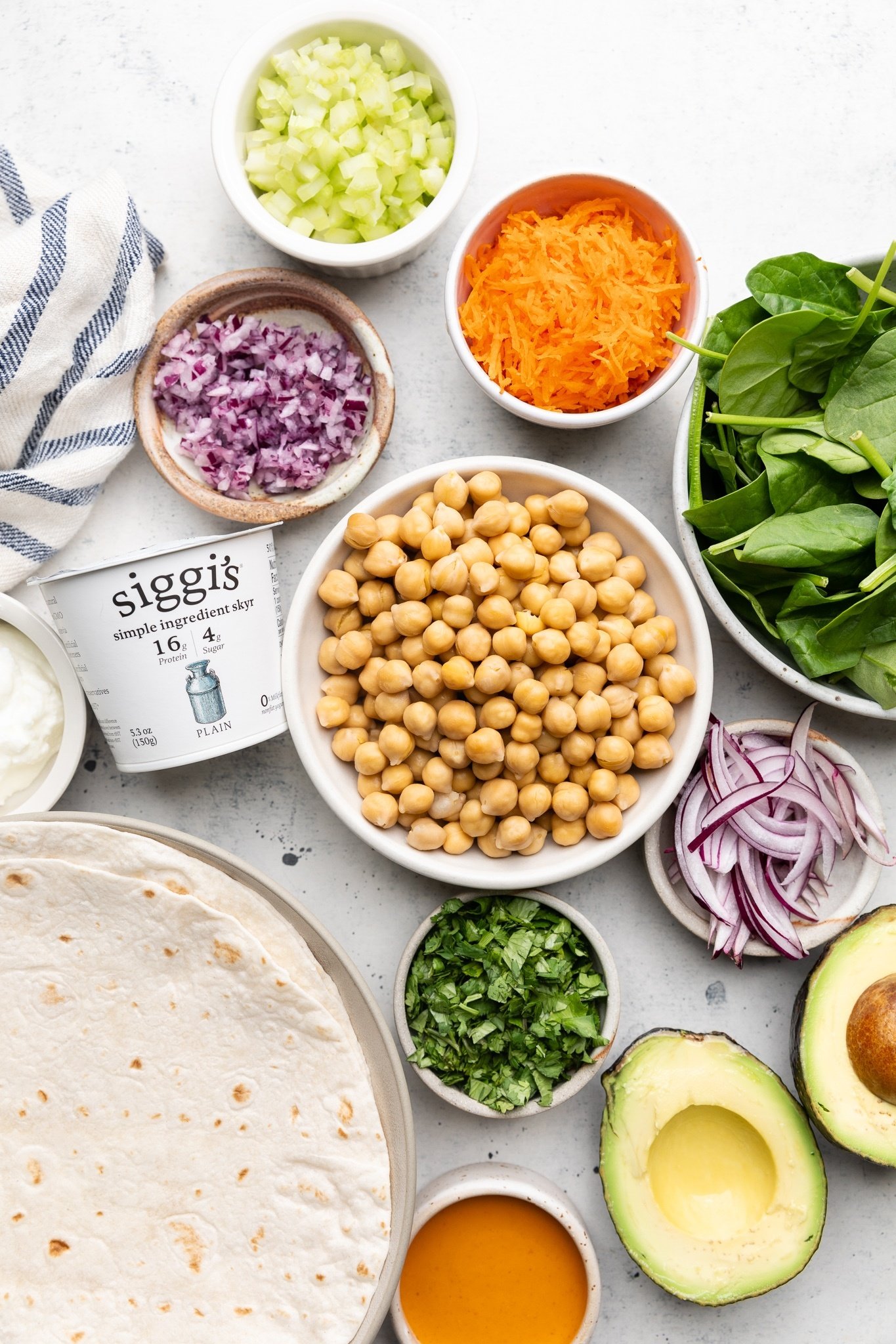 ingredients for buffalo chickpea salad wraps in bowls