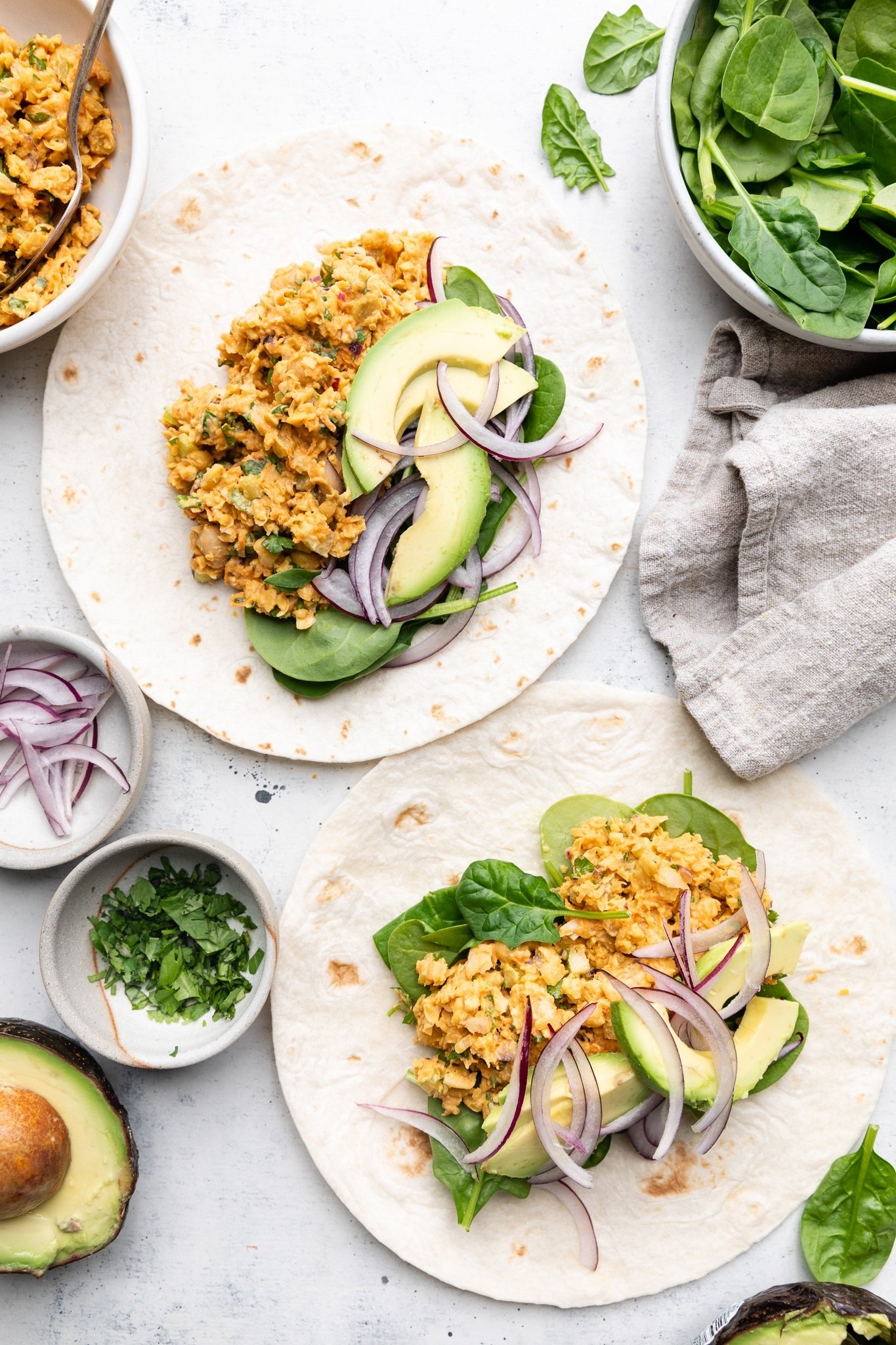 open-faced buffalo chickpea salad wraps on a board