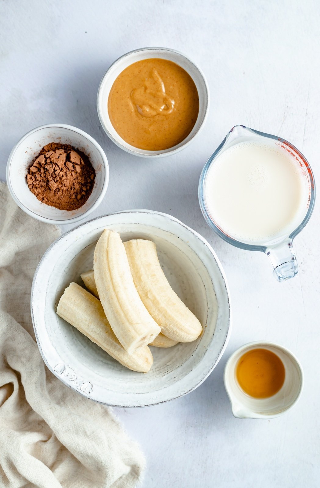 ingredients for a chocolate banana smoothie on a board