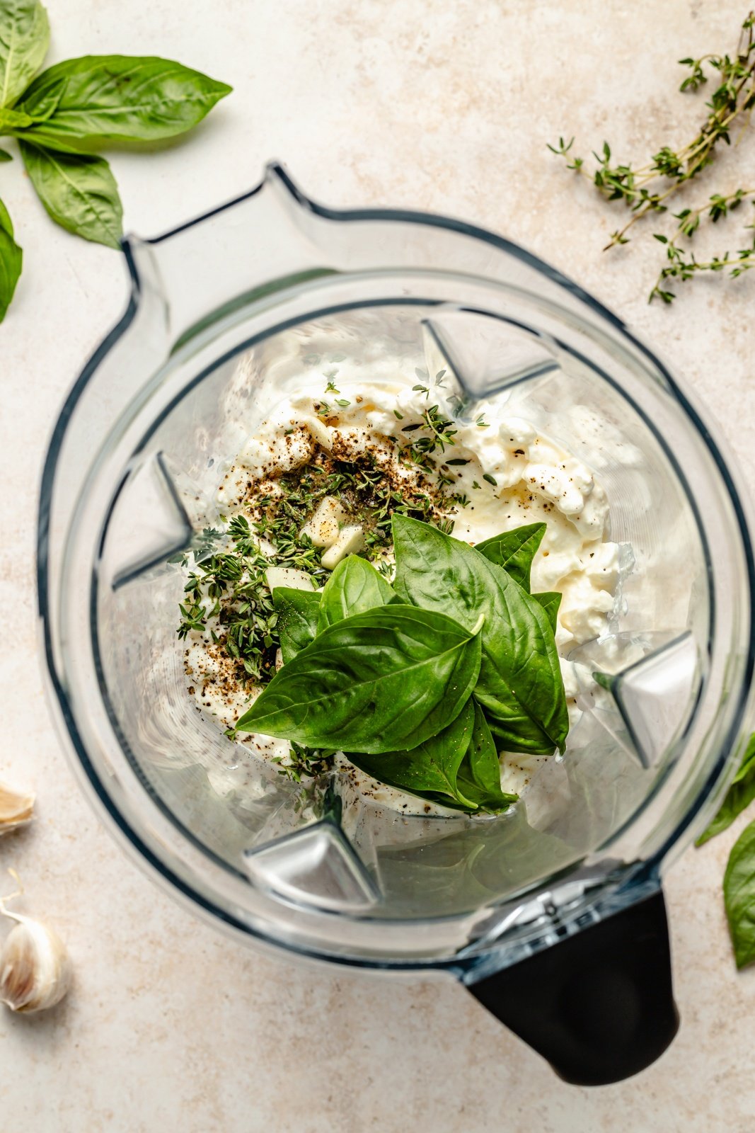 top-down view of ingredients for an herb cottage cheese dip in a blender