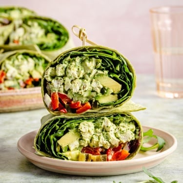 green goddess chicken salad wrap halves stacked on a plate