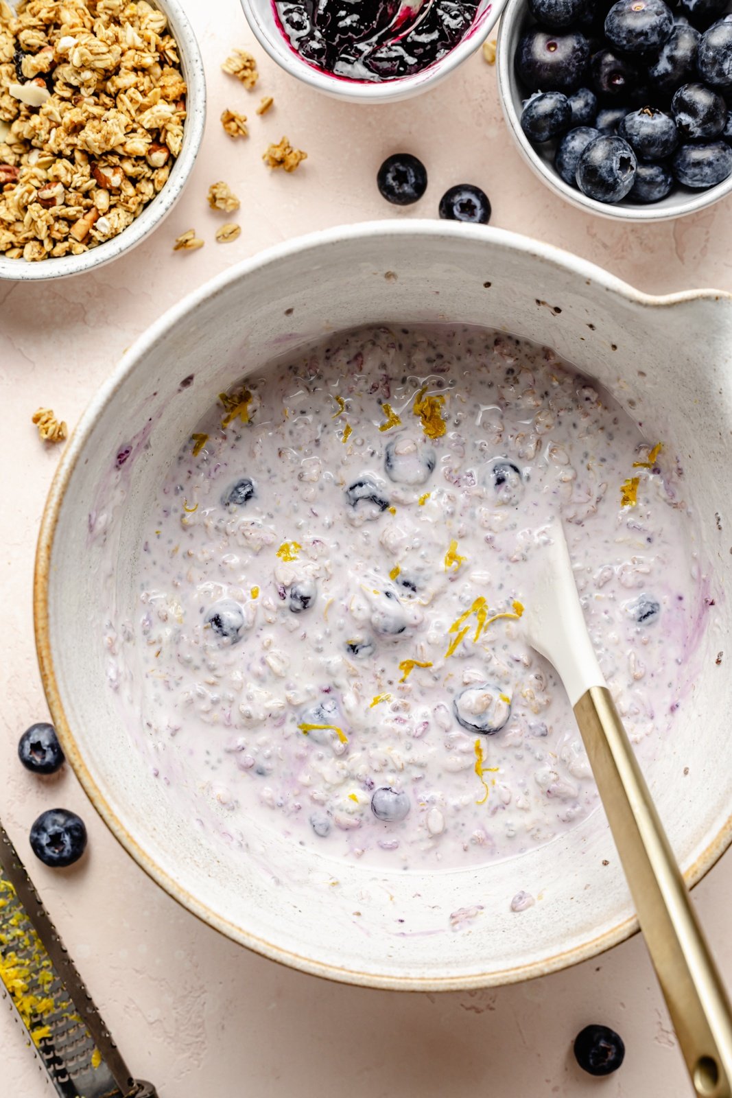 mixing ingredients for blueberry lemon overnight oats in a bowl