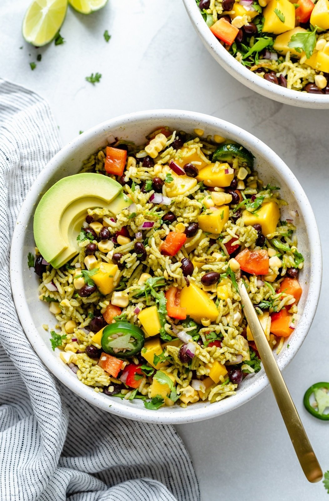 vegan green rice bowl with avocado, mango and black beans