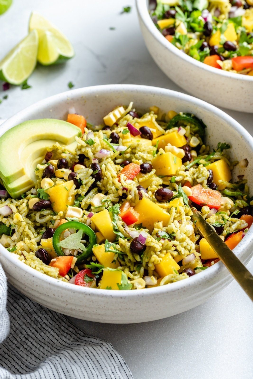 healthy green rice burrito bowl with avocado and mango