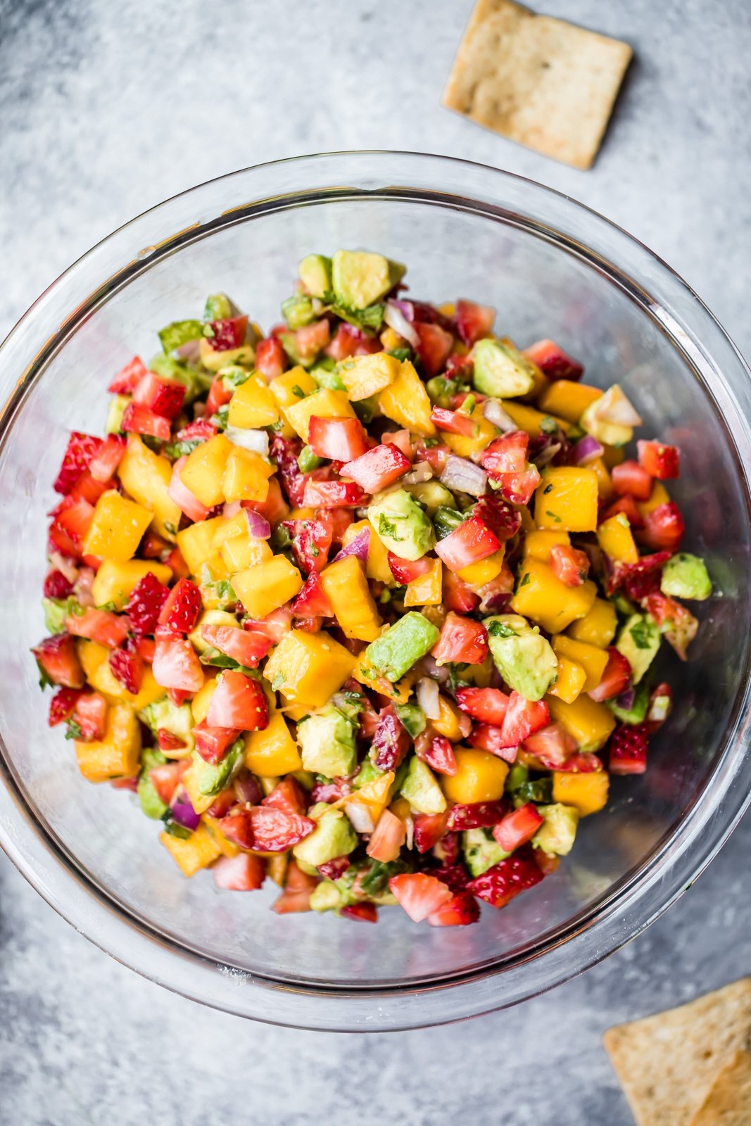 fresh strawberry avocado mango salsa in a glass bowl