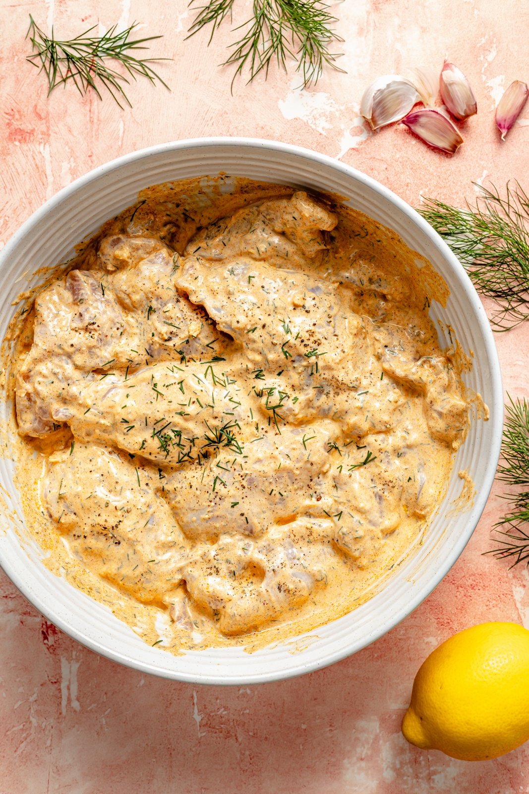 marinating chicken to make grilled mediterranean chicken