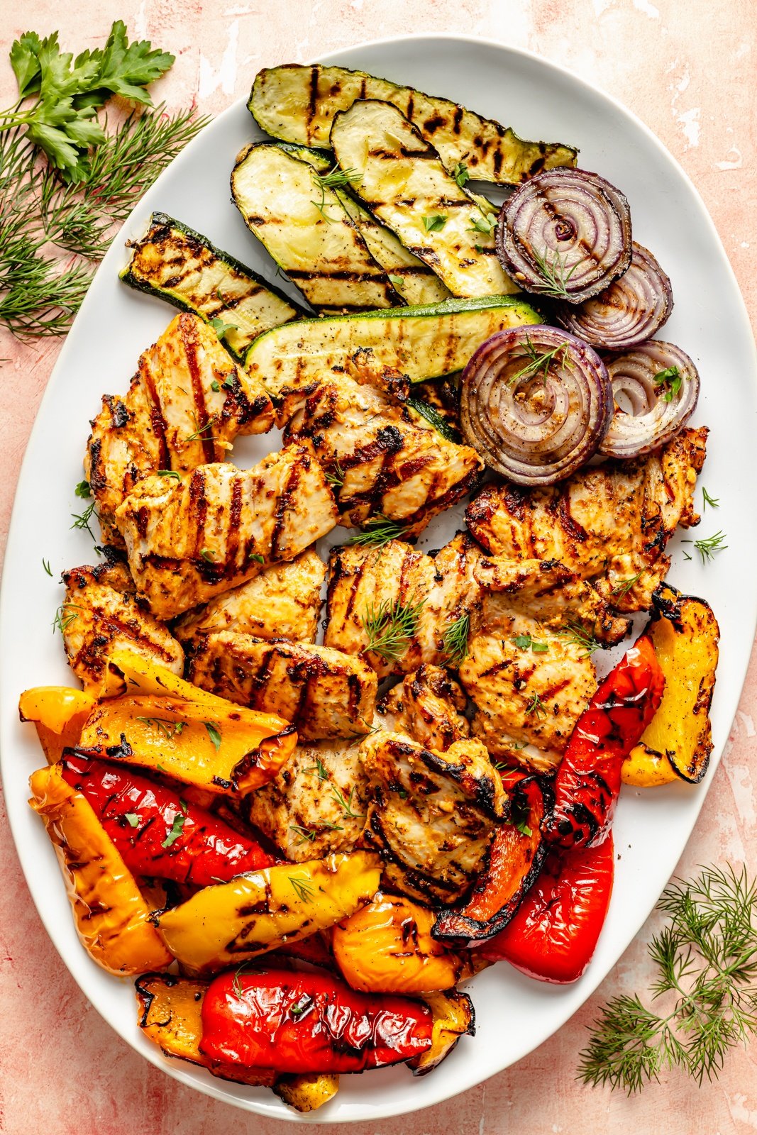 grilled mediterranean chicken and vegetables on a platter