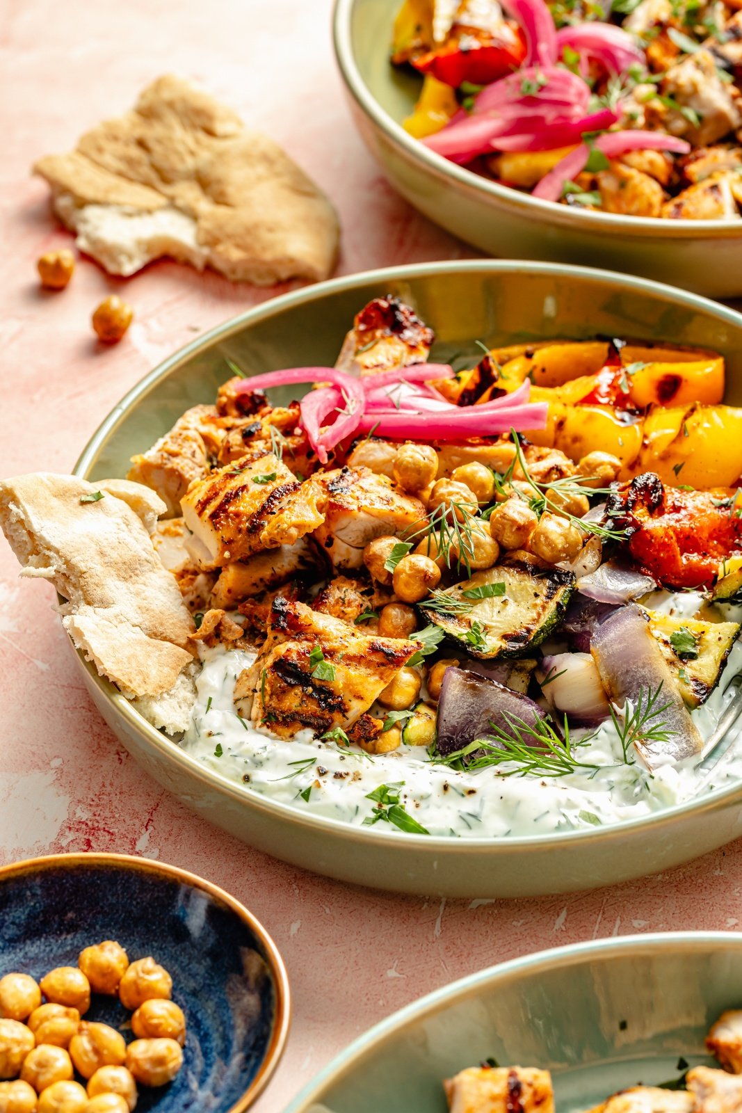 grilled mediterranean chicken in a bowl with vegetables and tzatziki sauce