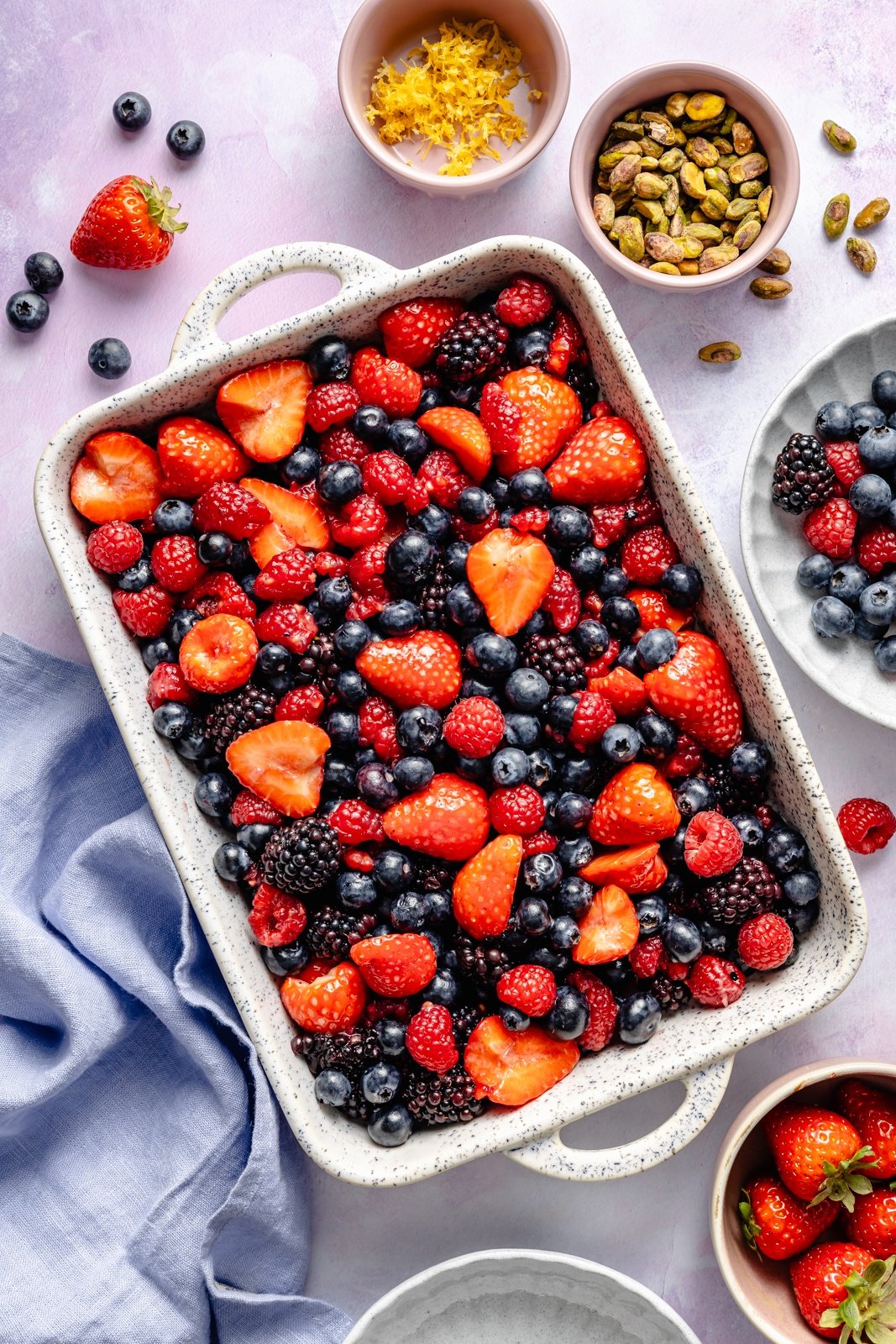 mixed berries in a baking pan to make a berry cobbler