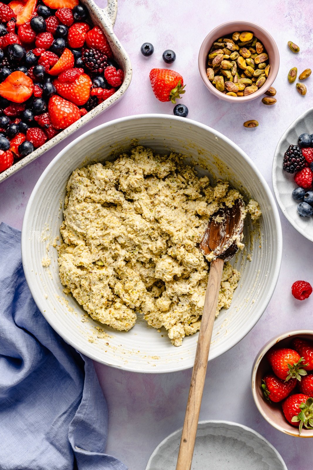 mixing biscuit dough for a berry cobbler recipe