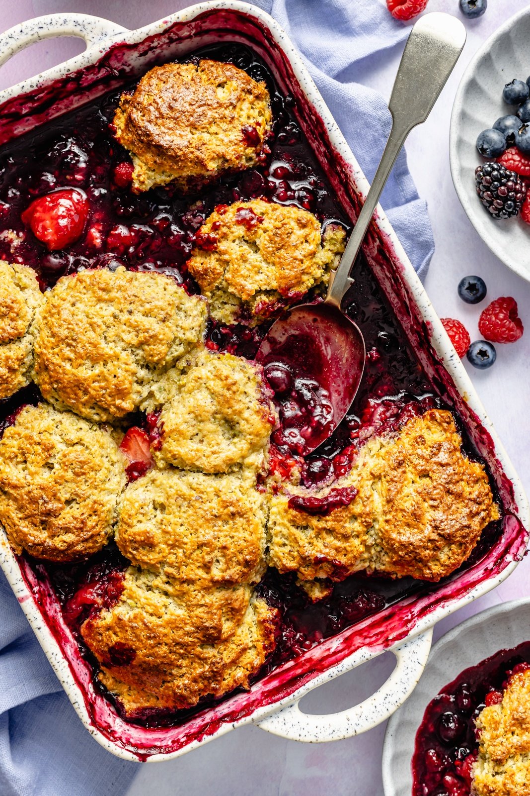 berry cobbler in a pan with a spoon