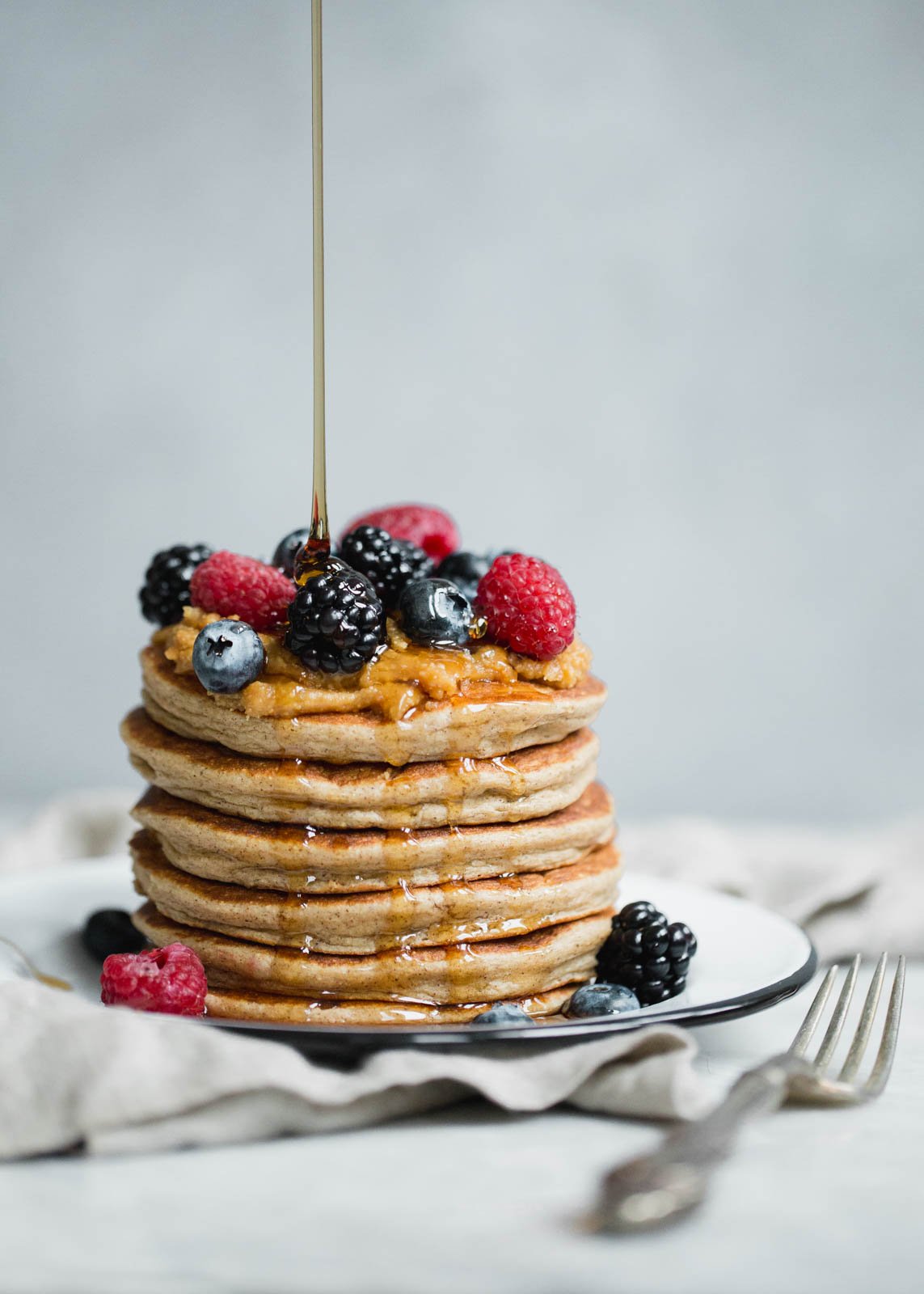 stack of protein pancakes topped with berries