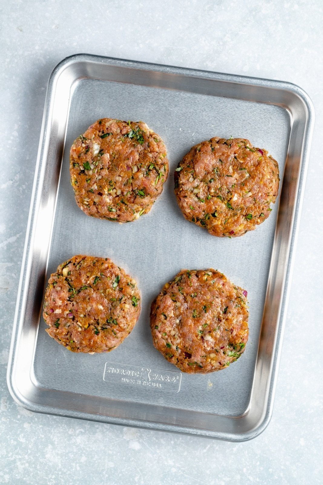 moroccan turkey burgers on a baking sheet before grilling