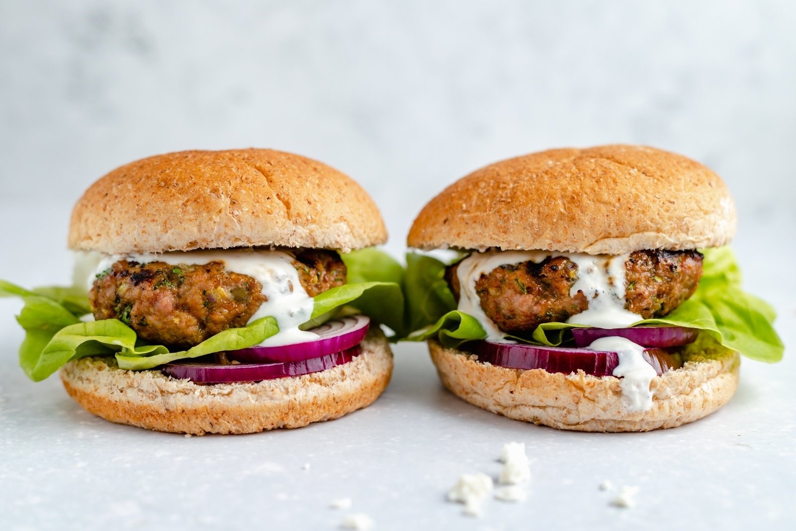 two moroccan spiced turkey burgers next to each other