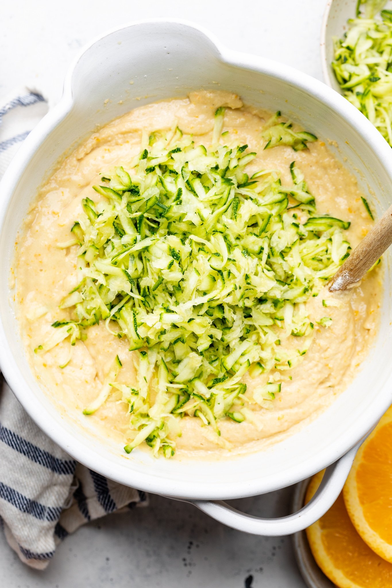 mixing ingredients for a gluten free orange zucchini cake