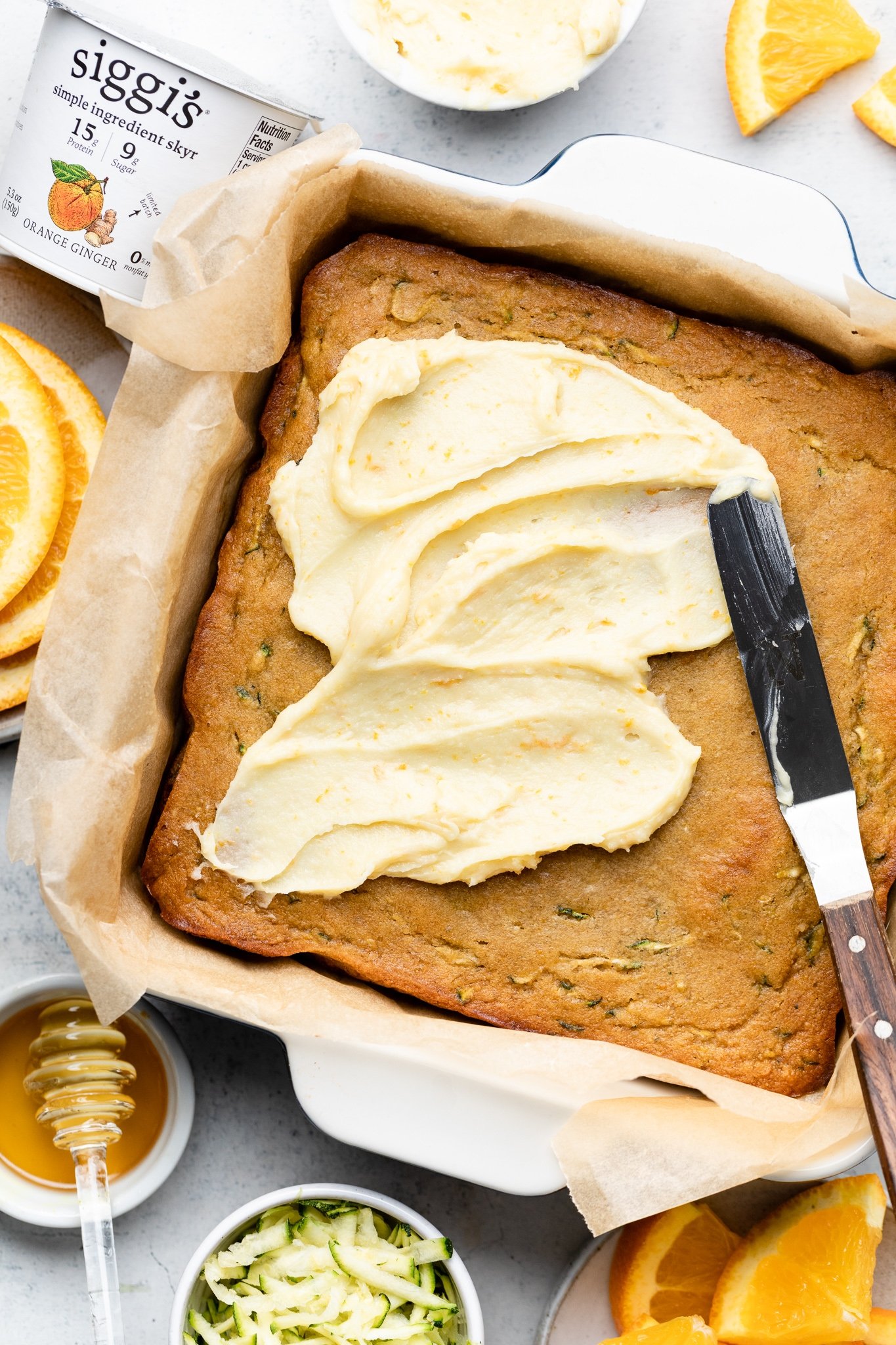 frosting an orange zucchini cake
