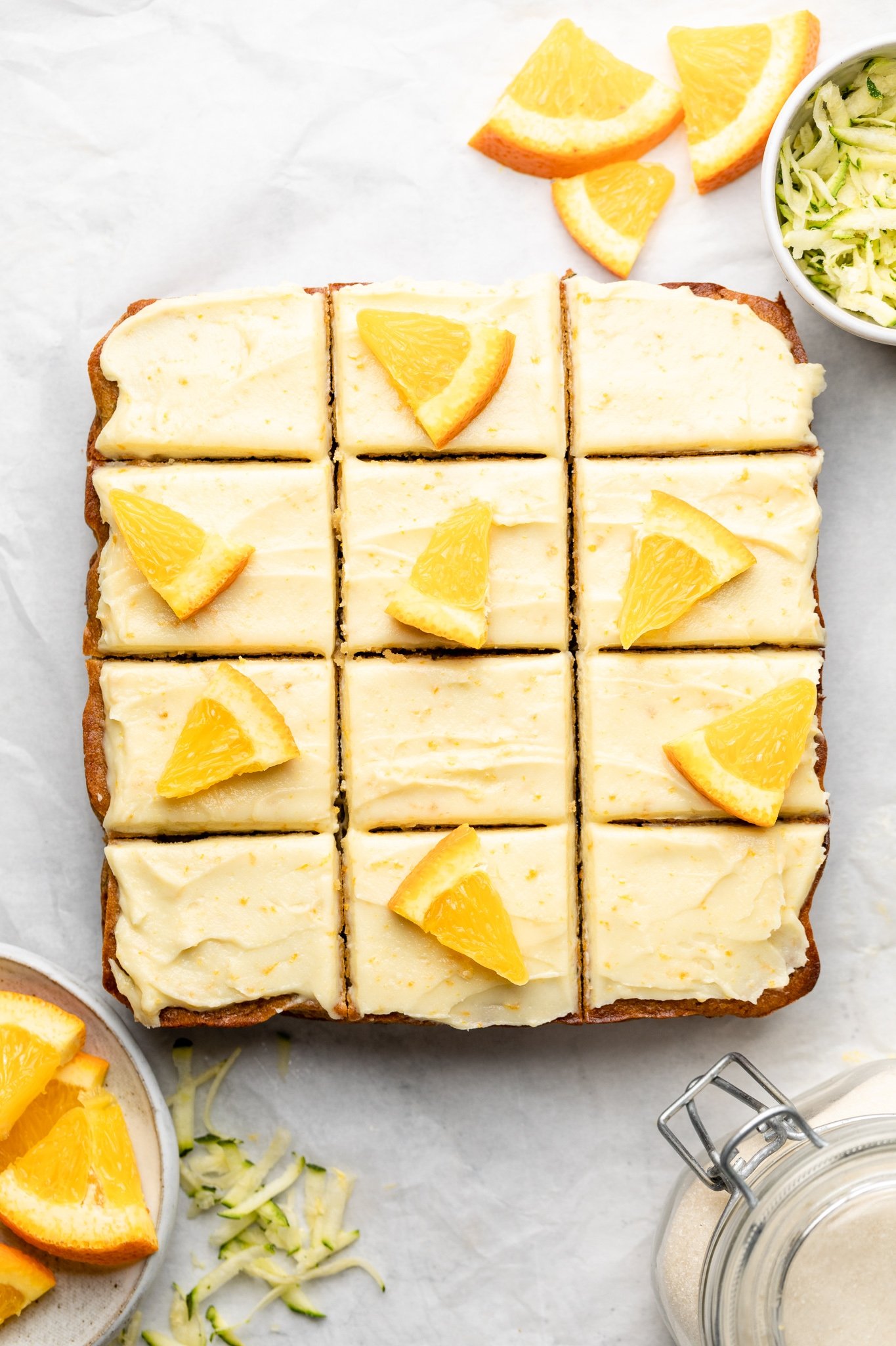 orange zucchini cake sliced on parchment paper