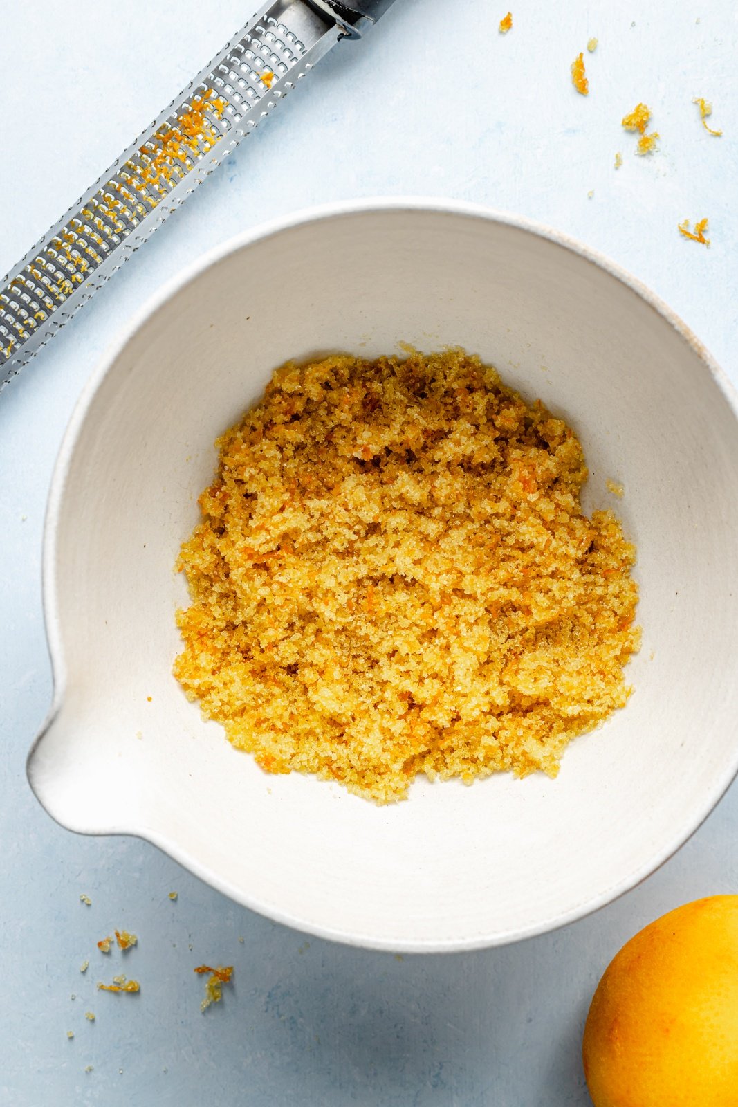orange zest in a bowl to make orange muffins