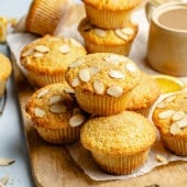 bakery-style orange muffins on a wooden board
