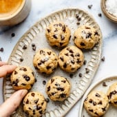 grabbing a protein cookie dough bite off of a platter