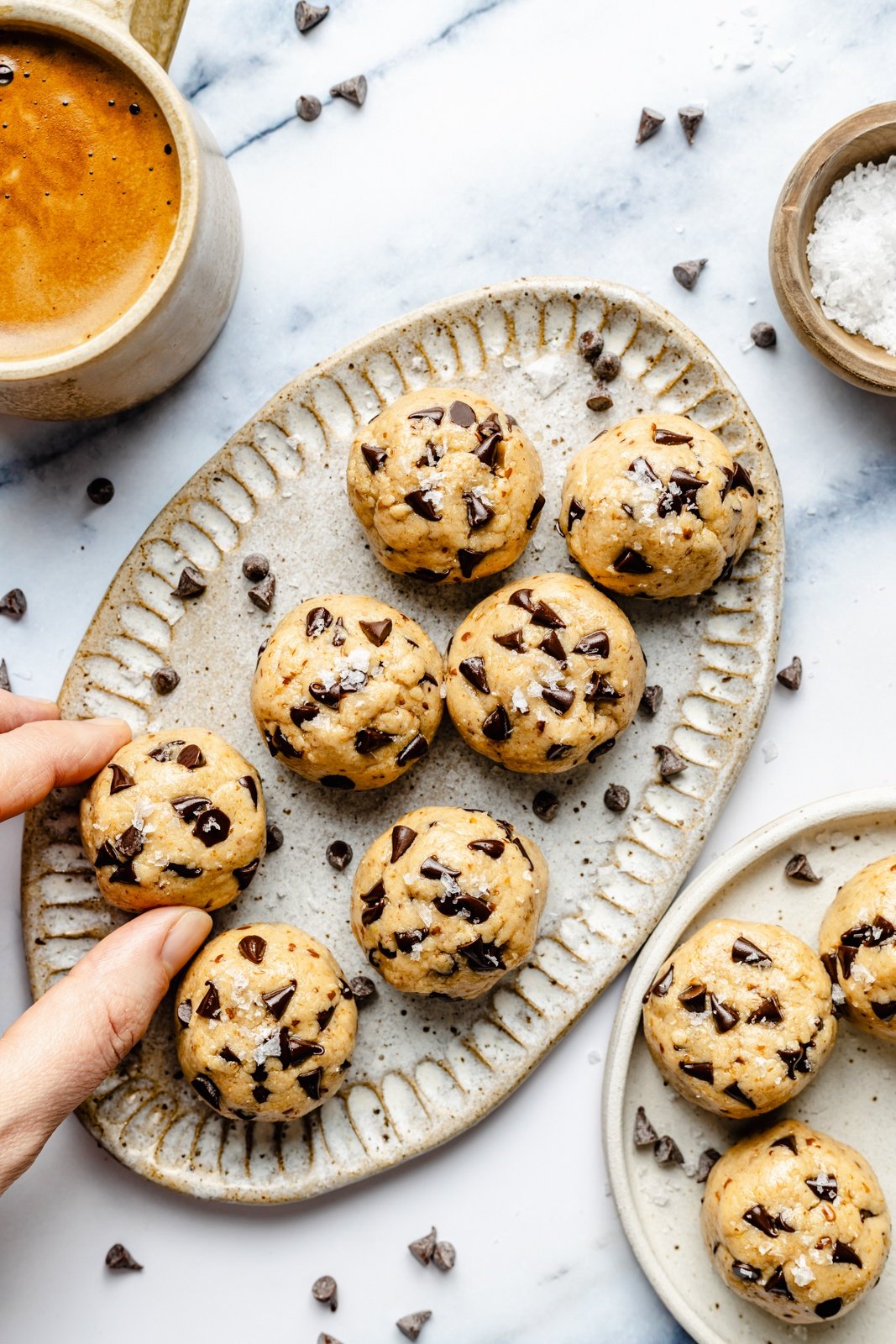 grabbing a protein cookie dough bite off of a platter