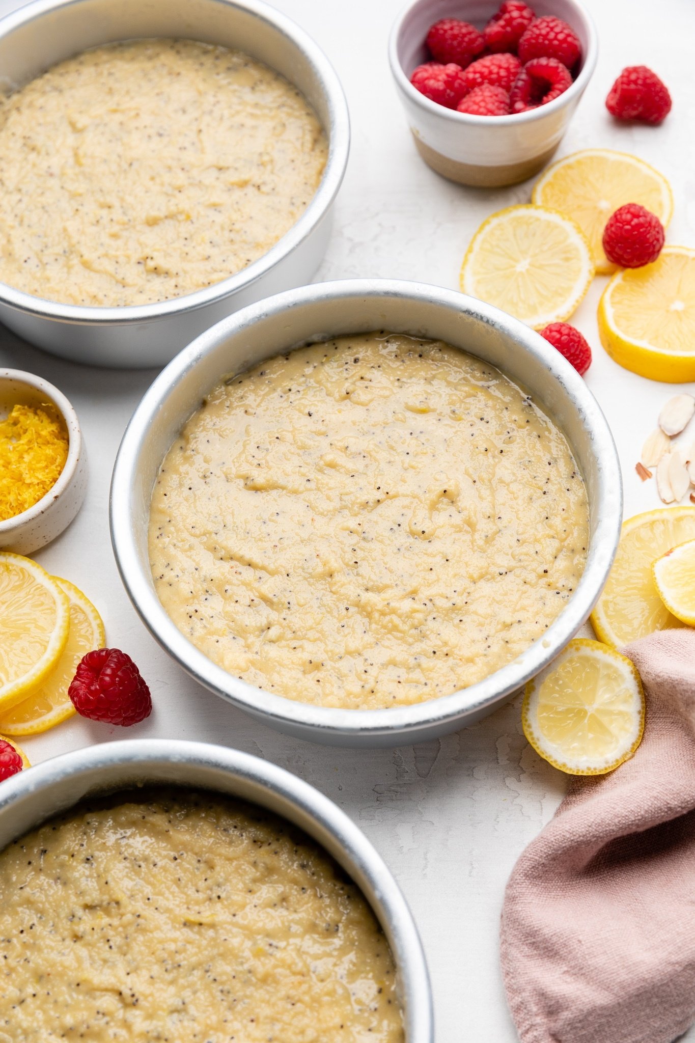 unbaked gluten free lemon raspberry cake in pans