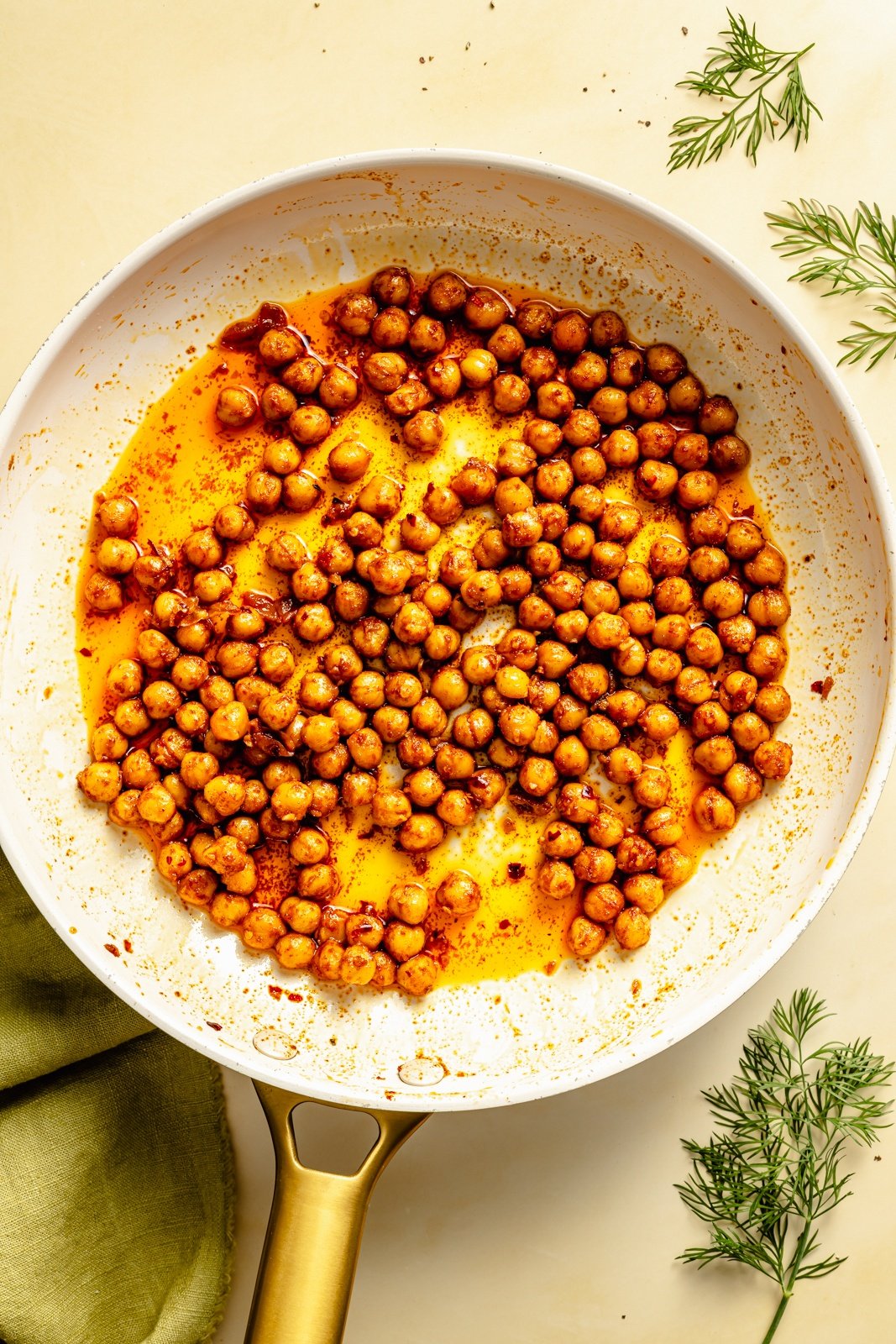 cooking spiced chickpeas in a skillet