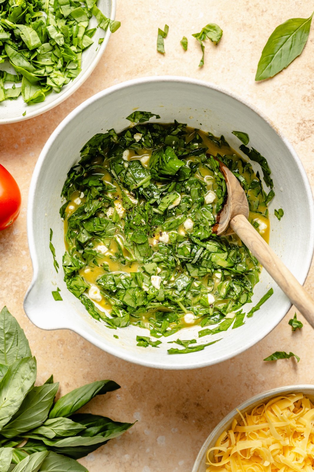 whisking ingredients in a bowl for a spinach tortilla quiche