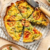 tomato basil tortilla quiche sliced in a pie pan