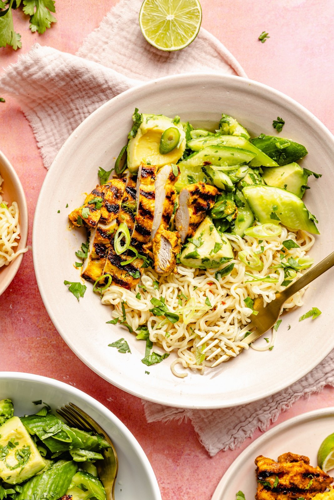 grilled turmeric chicken bowl with cucumber avocado salad and ramen