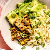 grilled turmeric chicken bowl with cucumber salad and ramen noodles