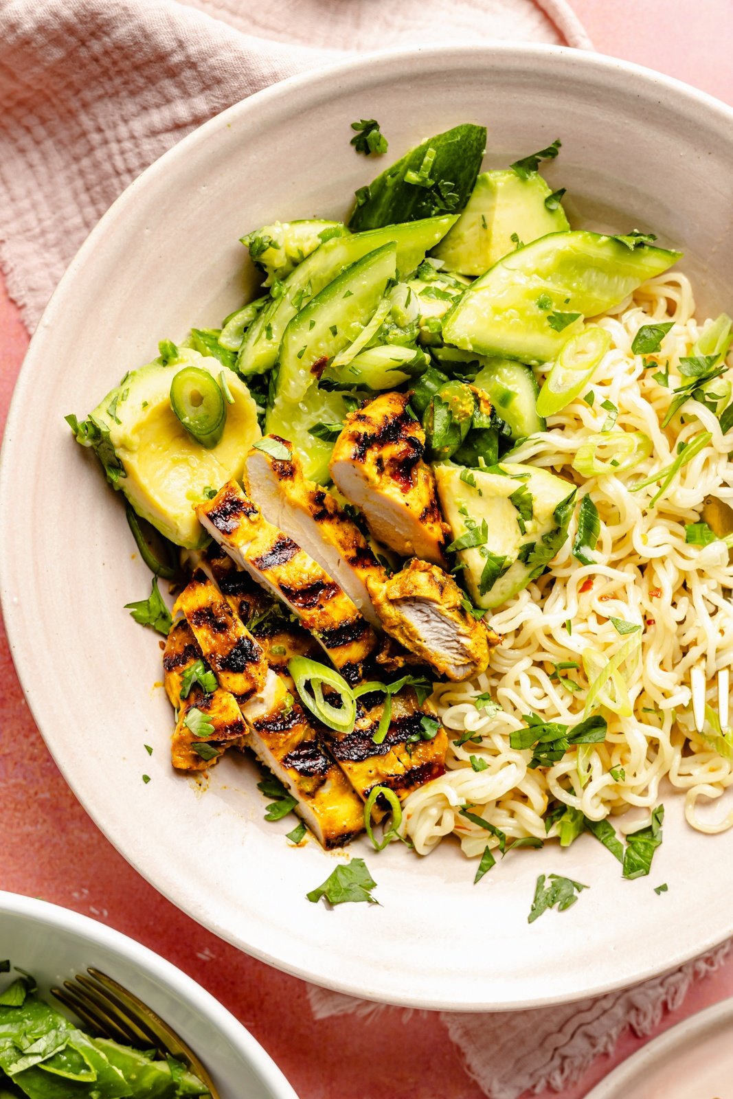 grilled turmeric chicken bowl with cucumber salad and ramen noodles